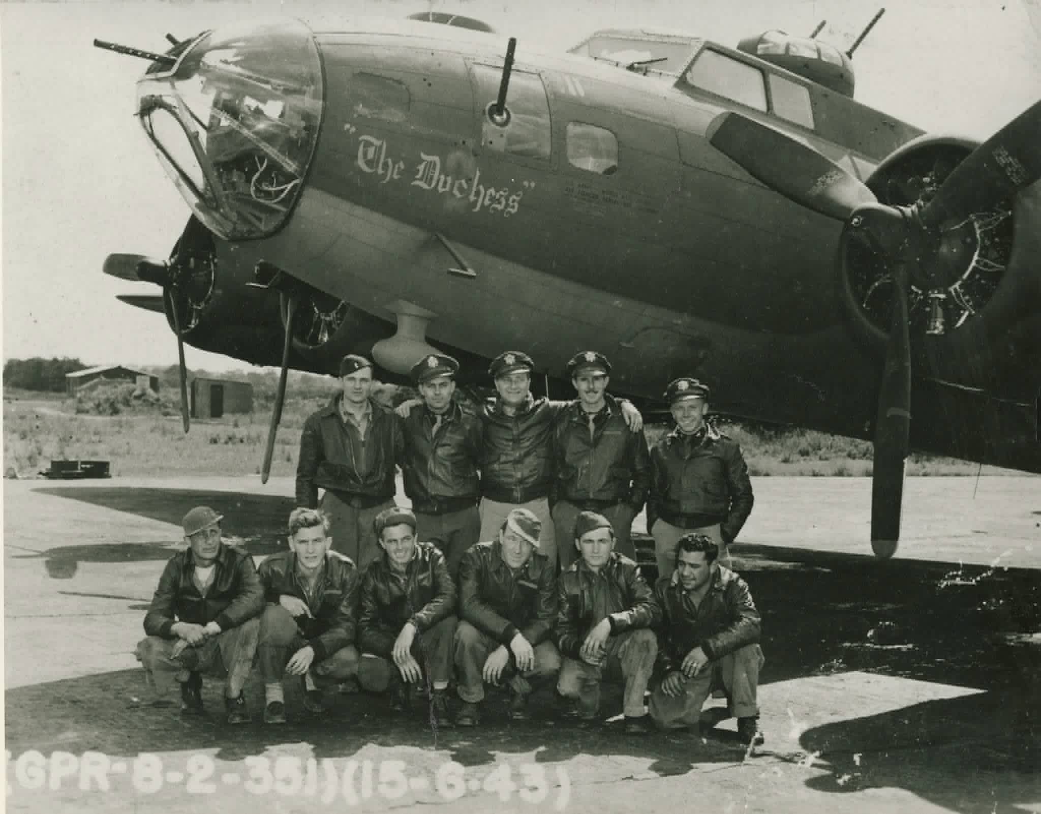 The Carraway crew of The Duchess (B-17F 42-29925) posed in front of the aircraft's nose art at Polebrook, June 1943 — five officers standing, six enlisted men kneeling