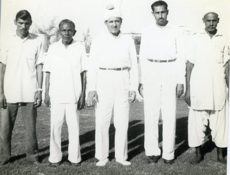 Bob Burns standing with the Pakistani household staff outside the MAAG residence in Karachi, mid 1960s