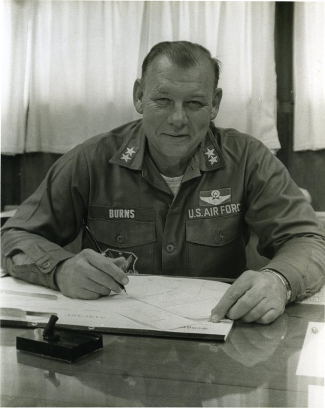 Maj. Gen. Burns signing papers at a desk in South Korea during the Pueblo deployment, 1968