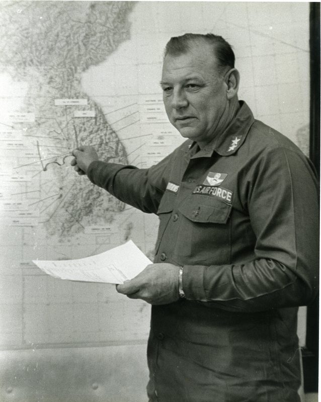 Bob Burns pointing at a wall map of Korea during the USS Pueblo crisis, 1968